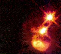В последние годы астрономы наблюдают все новые и новые примеры столкновений между галактикой, принадлежащей квазару, и соседними галактиками. Приливные силы толкают огромные массы газа в черную дыру квазара — “кормят” его.